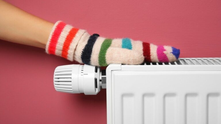 Gloved hand placed on top of a radiator